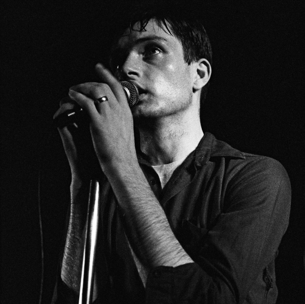 Singer Ian Curtis (1956 - 1980) performing with English rock group Joy Division at the Russell Club, also known as The Factory, Manchester, 13th July 1979. (Photo by Kevin Cummins/Getty Images)